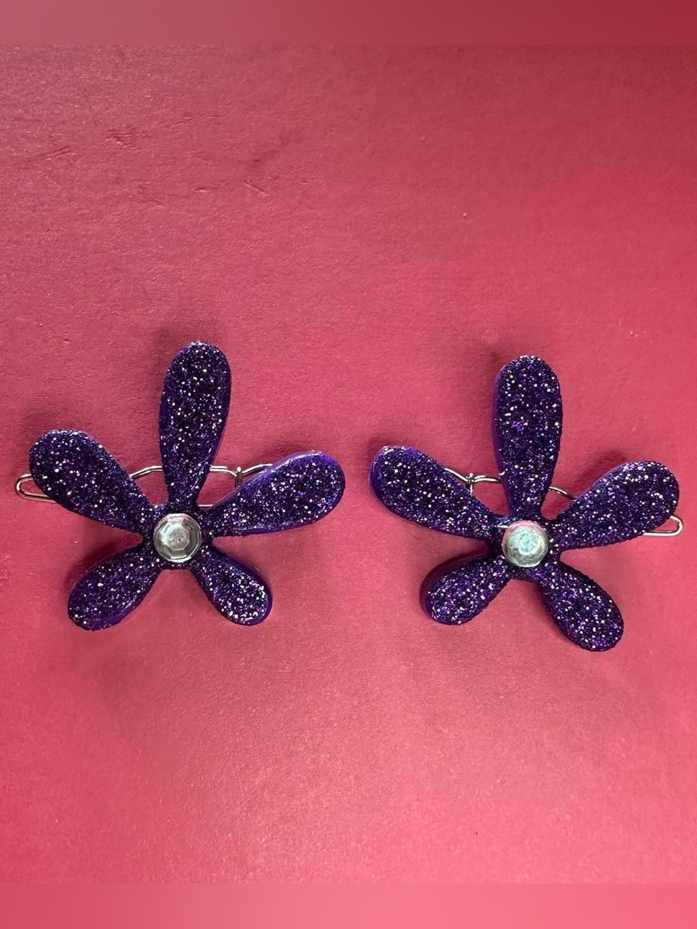 2 Purple plastic flower hair clips.